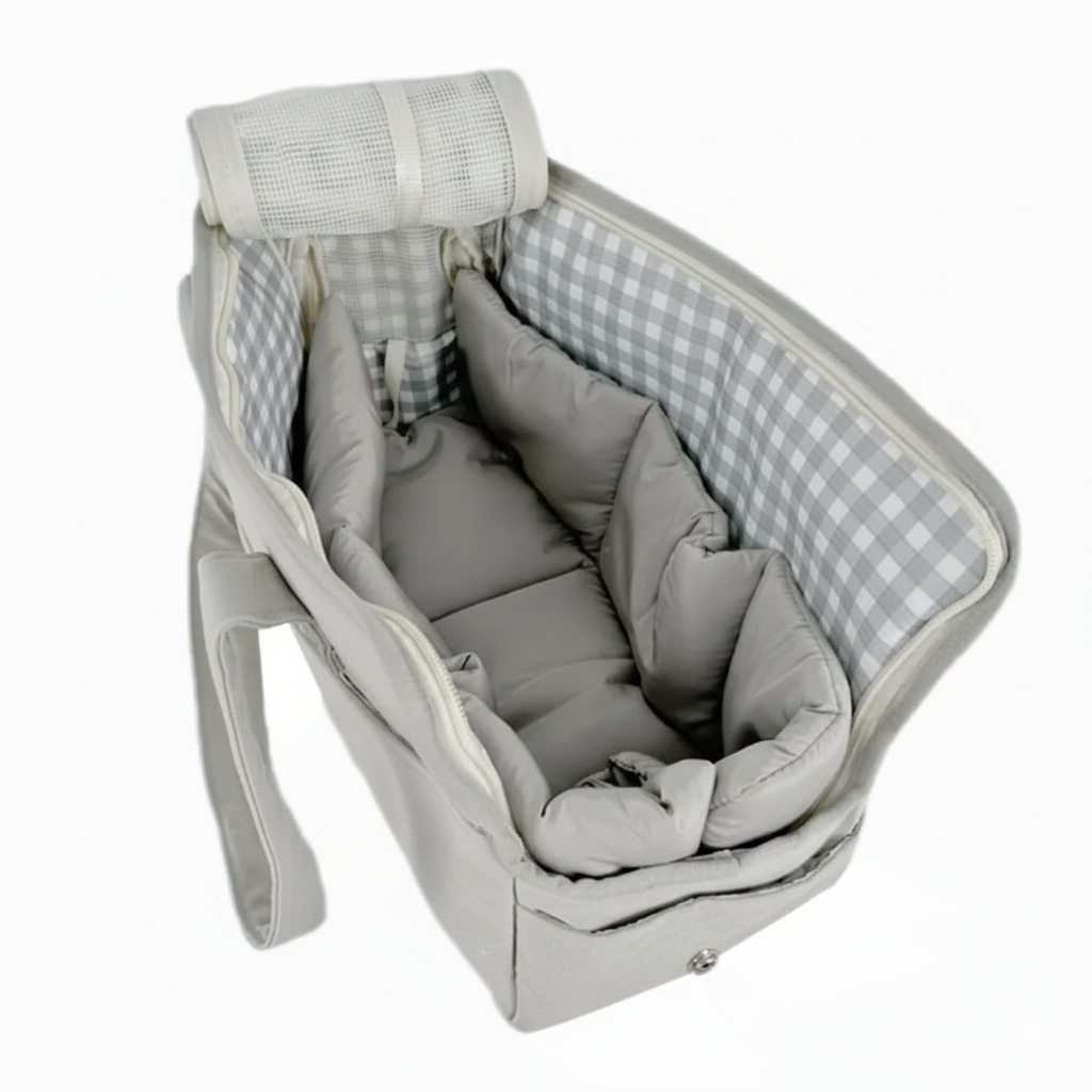 Gray baby crib with checkered sides and soft bedding on a white background