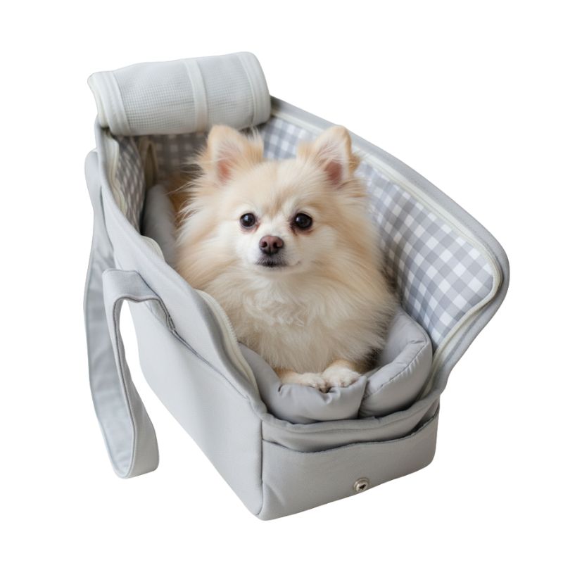 Small dog sitting in a gray pet carrier with a checkered lining on a white background