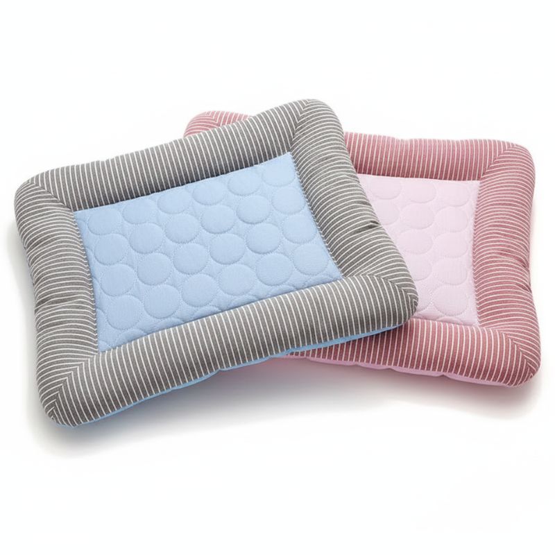 Three quilted pet beds in blue, gray, and pink on a white background