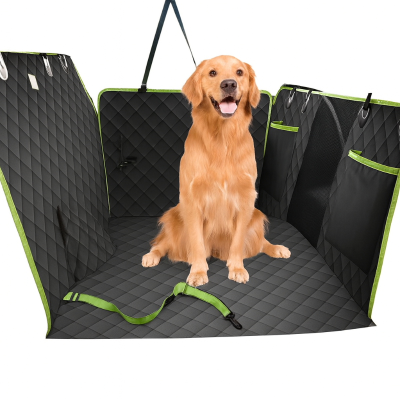 Dog sitting in a black and green car bench cover with a strap.