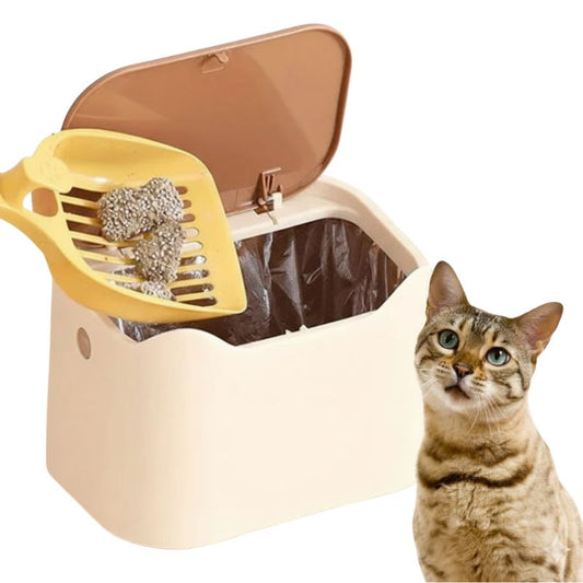 Cat litter box with yellow scoop and a cat sitting next to it on a white background
