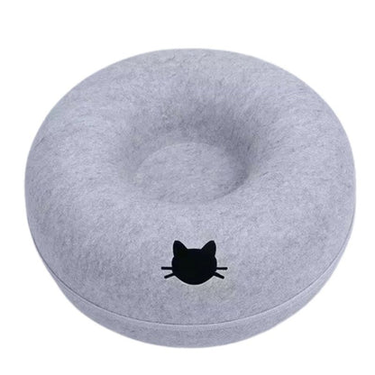 Gray donut-shaped pillow with a black cat face design on a white background
