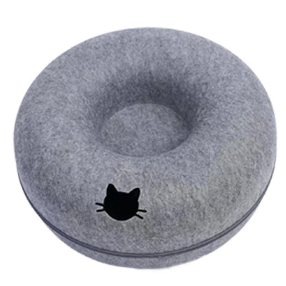 Gray donut-shaped pet bed with a black cat silhouette on a white background