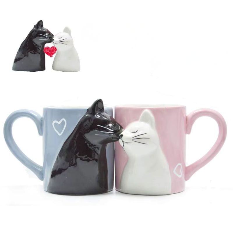 Two cat-shaped mugs, one black and one white, on a white background.