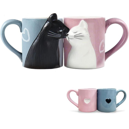 Two mugs with cat designs and two small matching mugs on a white background