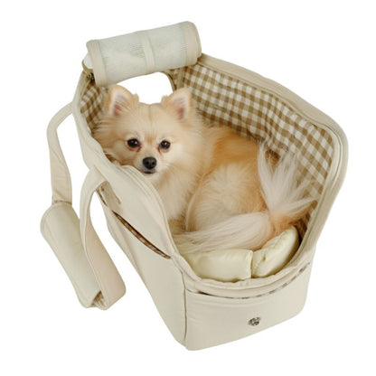 Small dog sitting in a beige pet carrier with a checkered interior on a white background