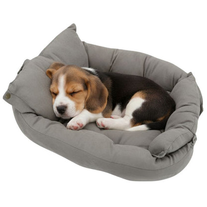 Puppy sleeping in a gray pet bed on a white background