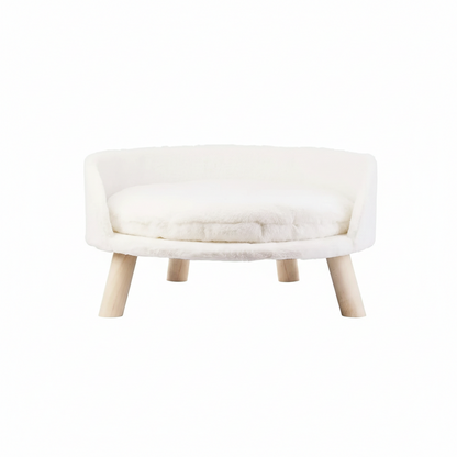 Small white pet bed with wooden legs on a white background