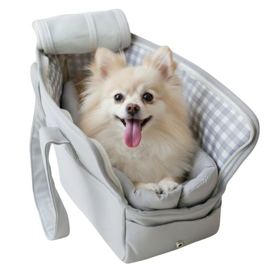 Small dog sitting in a pet carrier with a checkered pattern on a white background