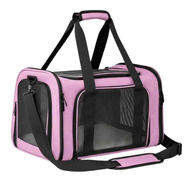 Pink pet carrier with black straps on a white background